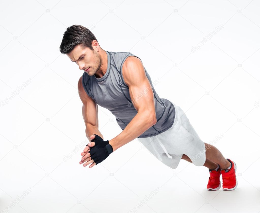 Fitness man doing exercises on the floor