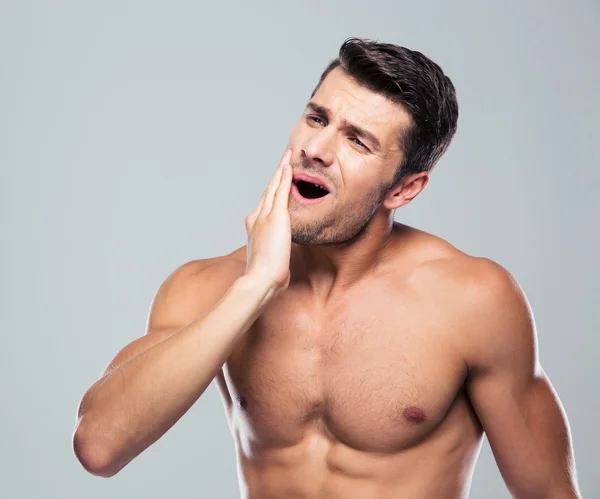 Fitness man with a toothache — Stock fotografie