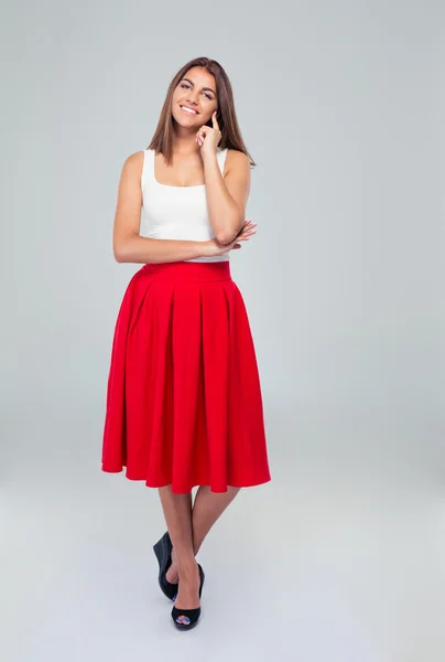 Beautiful happy woman in skirt looking at camera — Stock fotografie