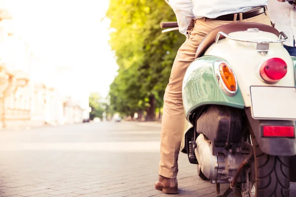 Closeup portrait of a scooter with male legs — Stockfoto
