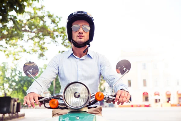 Man in helmet riding on scooter — Stok fotoğraf