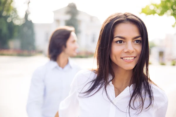 Happy young woman leading man — Stock Photo, Image