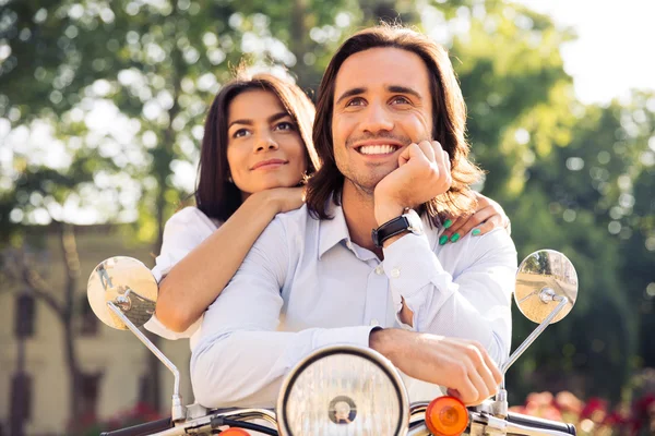 Happy thoughtful couple on scooter — Φωτογραφία Αρχείου
