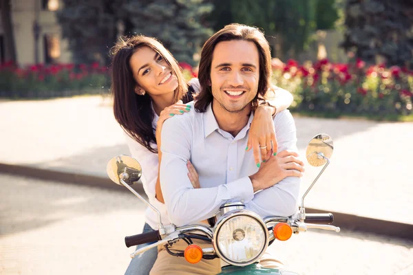 Couple on scooter in the town — Stok fotoğraf