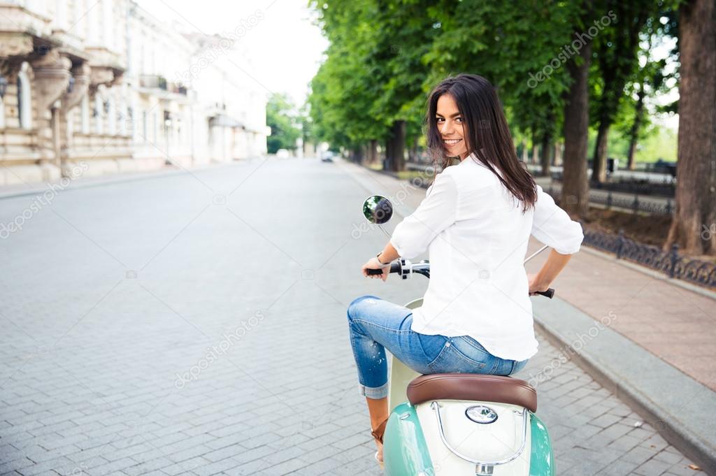 eautiful woman riding a scooter