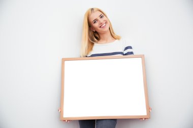 Casual businesswoman holding blank board