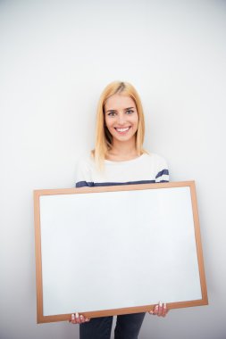 Beautiful girl holding blank board