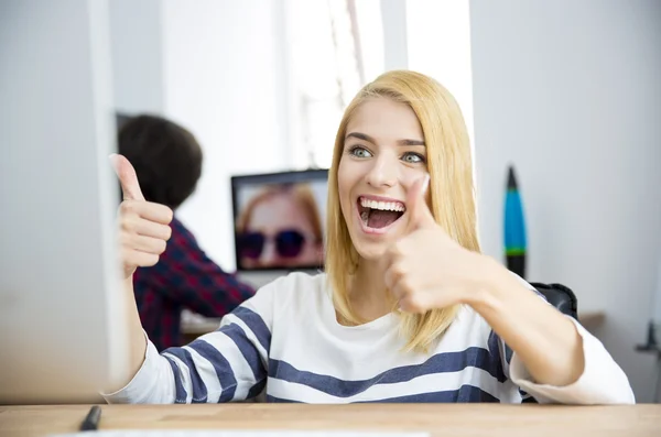 Laughing casual woman showing thumbs up — Stok fotoğraf