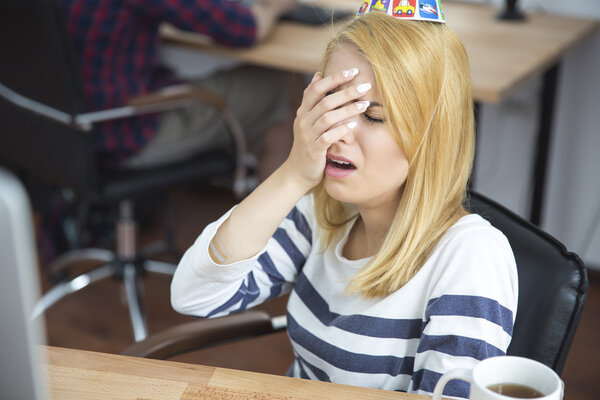 Frustrated young woman in office