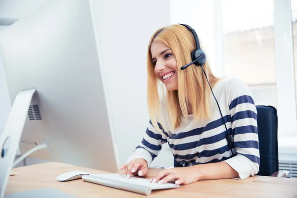 Cheerful young female operator with headset — Stock fotografie