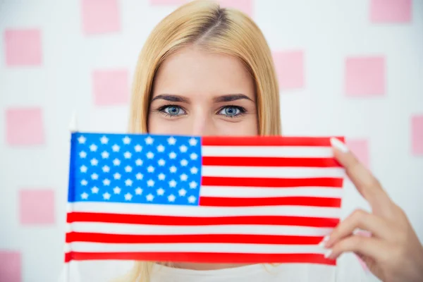 Woman covering her face with USA flag — Stockfoto