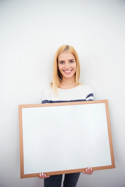 Beautiful girl holding blank board — Stock Photo, Image
