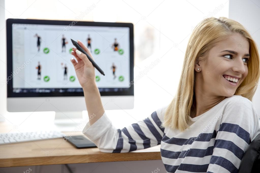 Young girl pointing pen on monitor 