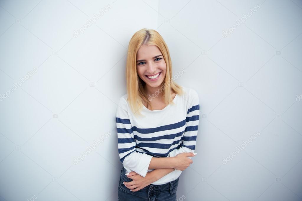 Happy young girl standing with arms crossed