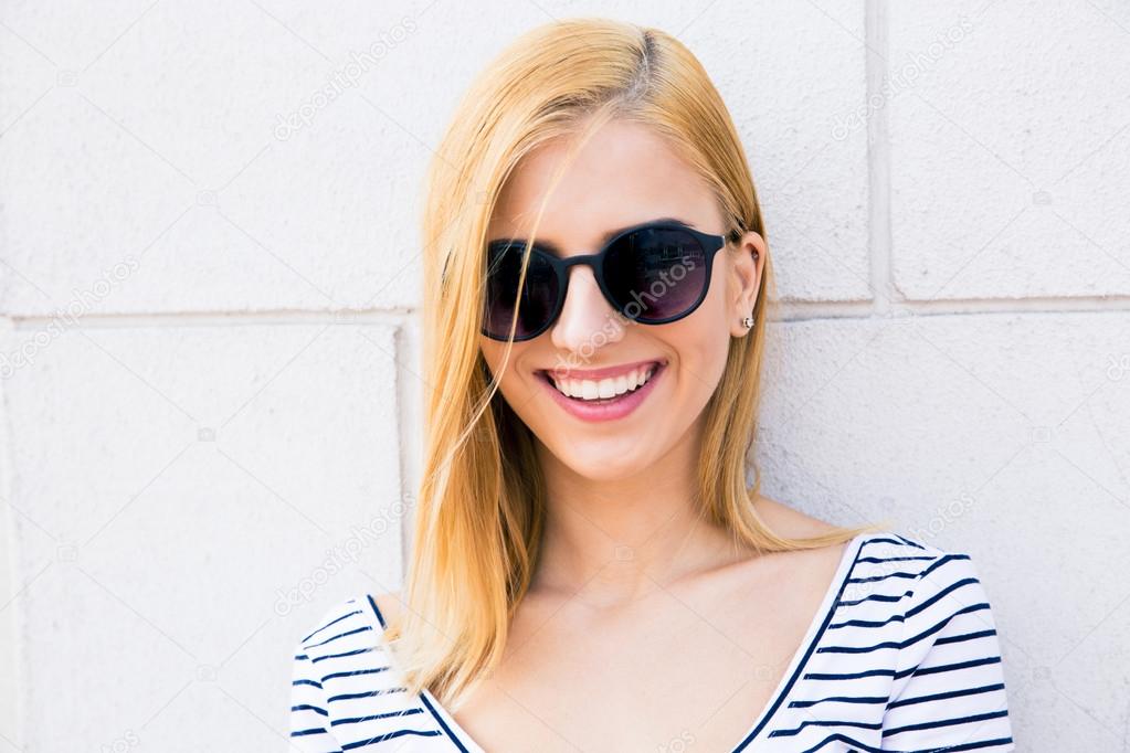 Smiling female teenager in sunglasses