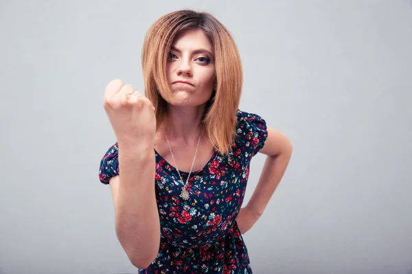 Angry young woman showing fist — Stock Photo, Image