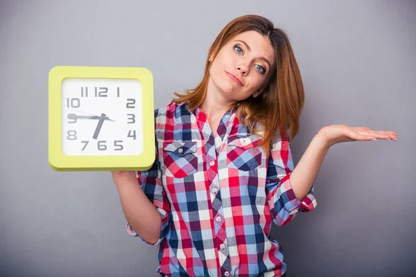 Young casual woman holding clock — Stock Photo, Image