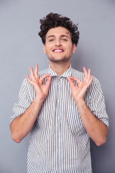 Smiling man holding his collar — Stock Photo, Image