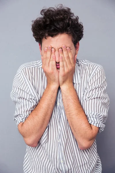 Man covering his face with palms — Stock Photo, Image