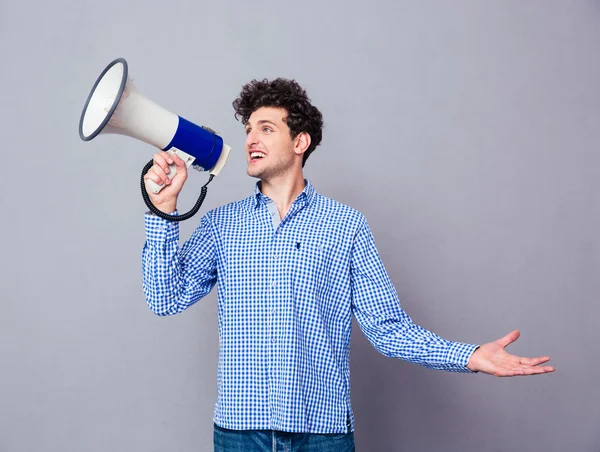 Casual man screaming on megaphone — Stock Photo, Image