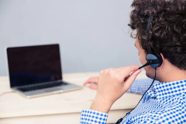 Achteraanzicht portret van een mannelijke operator met hoofdtelefoons — Stockfoto