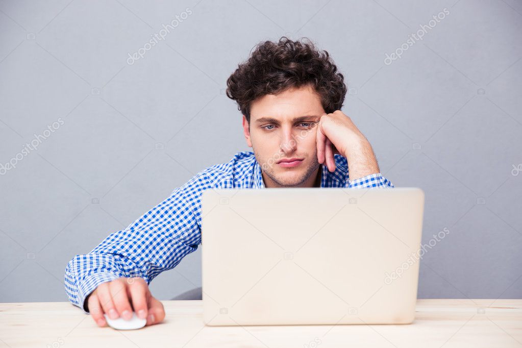 Casual young man using laptop