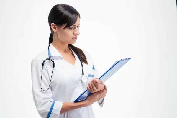 Hermoso médico leyendo notas en el portapapeles —  Fotos de Stock