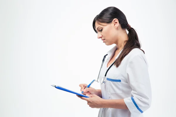 Medical doctor writing notes in clipboard — Stock Photo, Image