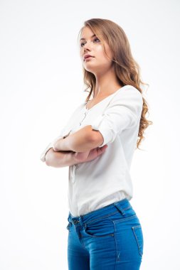 Serious woman standing with arms folded clipart