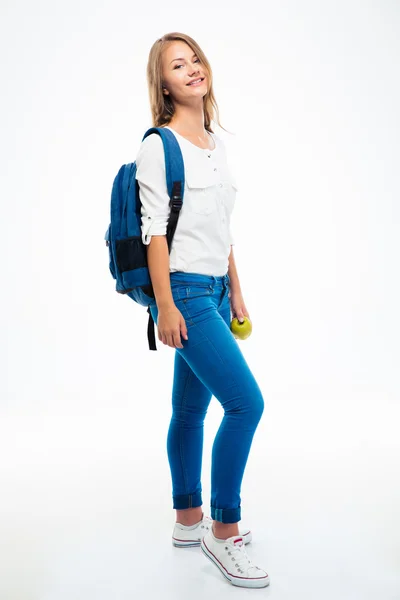 Leende ung flicka med ryggsäck och äpple — Stockfoto