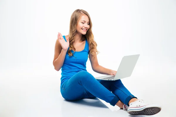 Happy girl showing greeting gesture at laptop — Stock Photo, Image