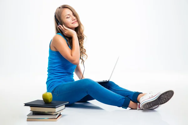 Girl listening music in headphones on the floor — Stock Photo, Image