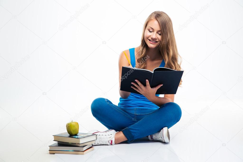 Girl sitting on the floor and writing notes