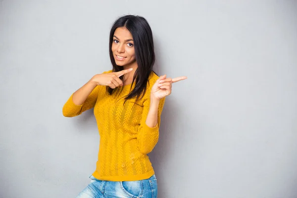 Happy woman showing finger away — Stock Photo, Image