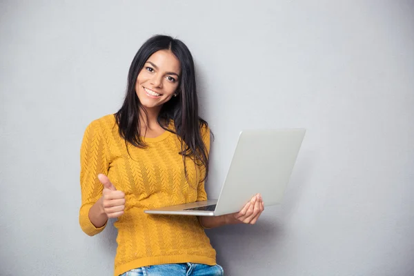 Smiling beautiful woman holding laptop — Stock Photo, Image