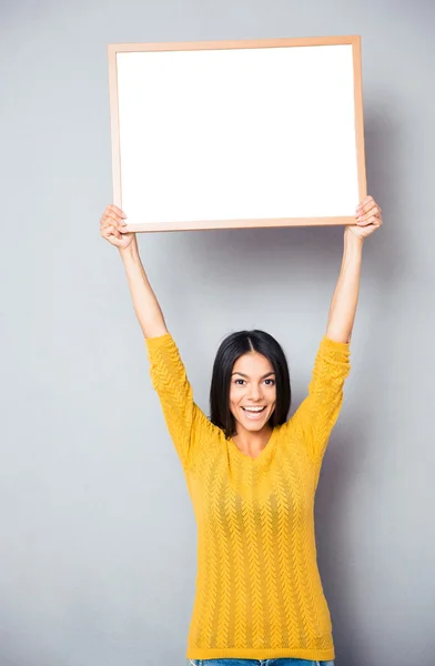 Smiling woman holding blank board — Stock Photo, Image