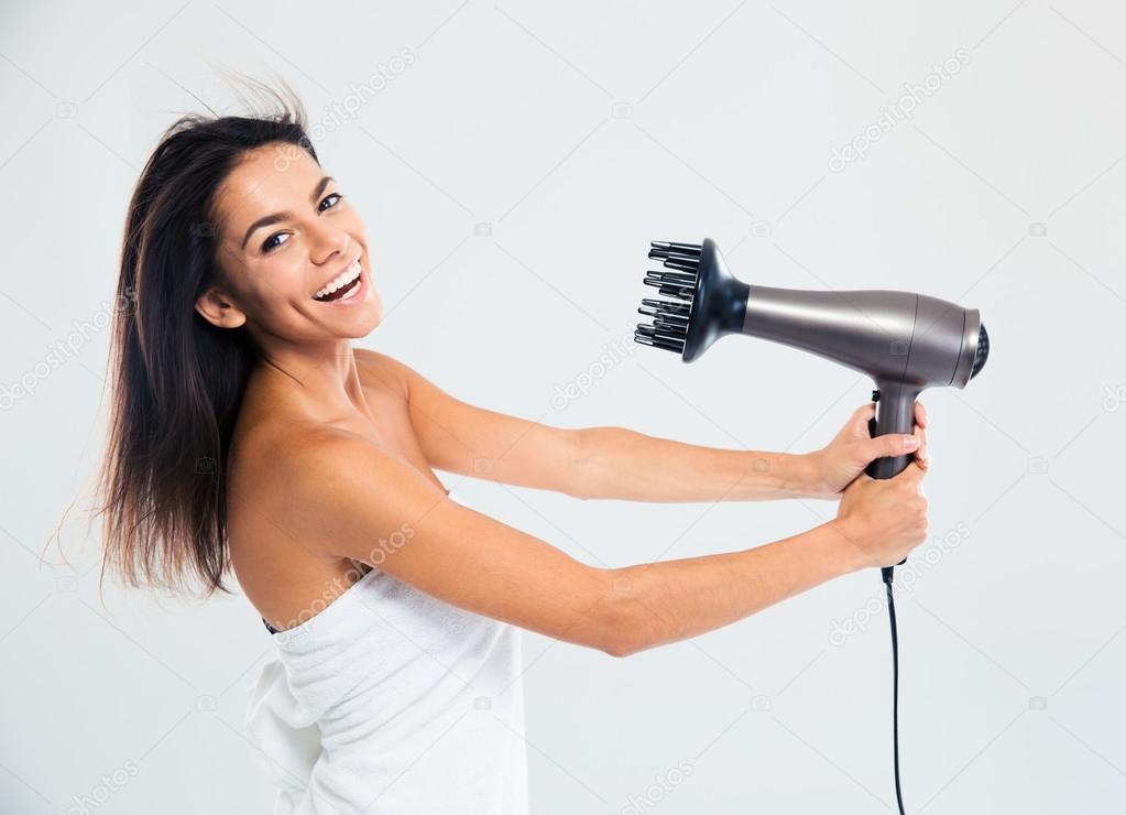 Laughing woman in towel drying her hair 