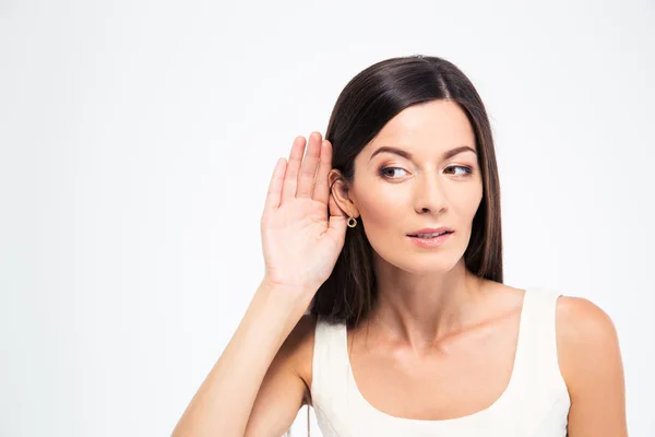 Woman puts a hand to the ear — Stock Photo, Image