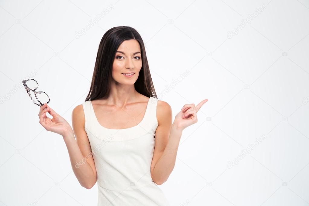 Woman holding glasses and pointing finger away