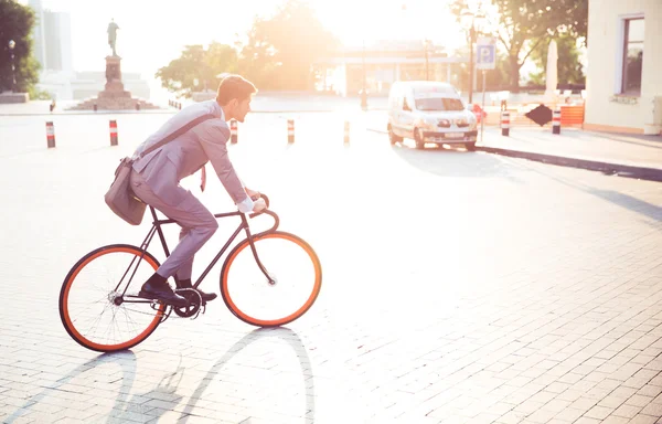 Businessman riding bicycle — Stock Photo, Image