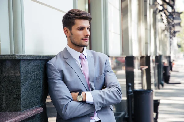 Portrait of a pensive businessman with arms folded — Stock Photo, Image