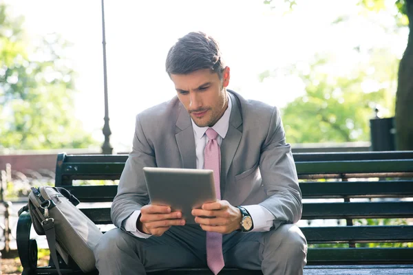 Businessman using tablet computer outdoors — Stock Photo, Image
