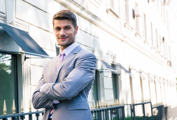 Businessman standing with arms folded — Stock Photo, Image