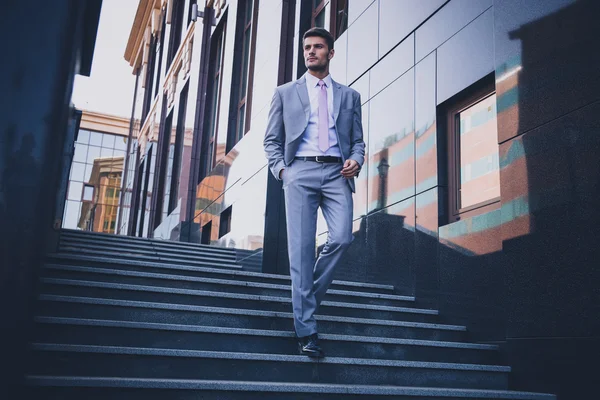 Businessman walking on the stairs outdoors — Stock Photo, Image