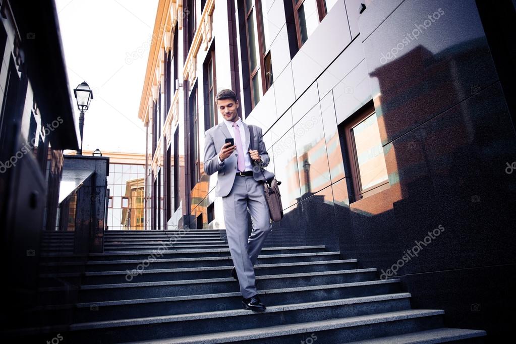 Businessman using smartphone outdoors