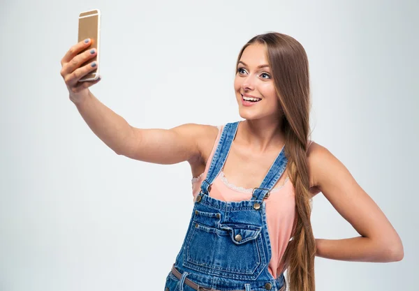 Smiling girl making selfie photo on smartphone — Stock Photo, Image