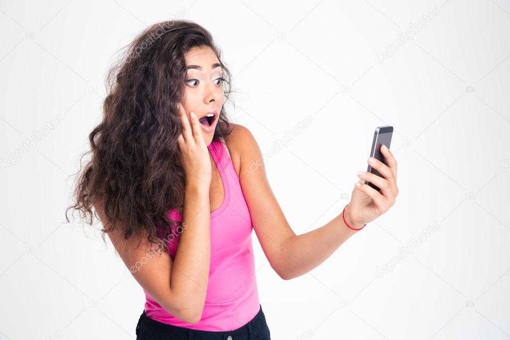 Surprised woman looking on smartphone