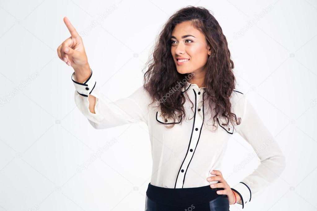 Smiling beautiful businesswoman pointing finger away