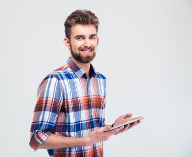 Man holding tablet computer and looking at camera clipart