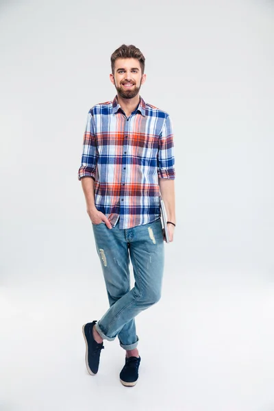 Full length portrait of a man standing with laptop — Stock Photo, Image